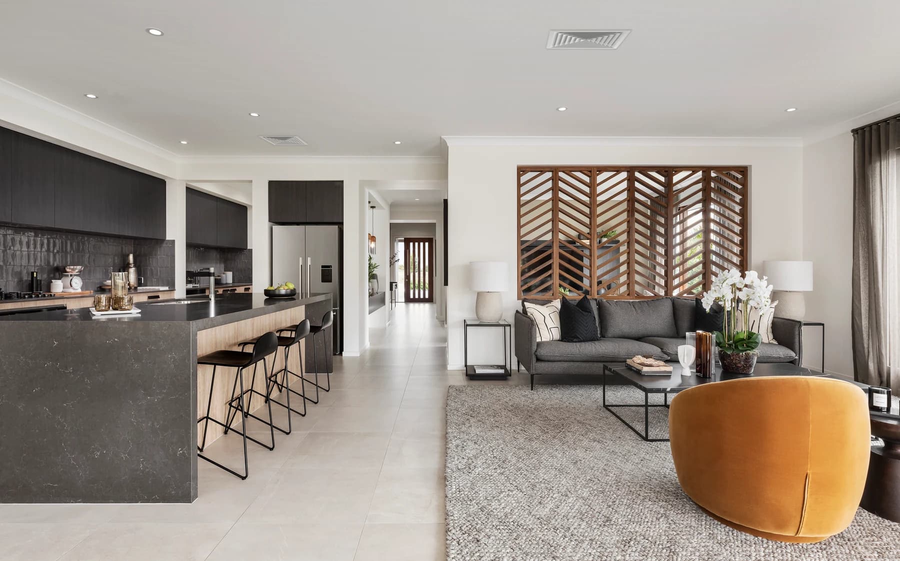 Living room and kitchen with square ceiling vents for ducted air conditioning