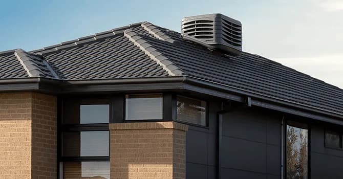 Roof-mounted evaporative cooler on a tiled home