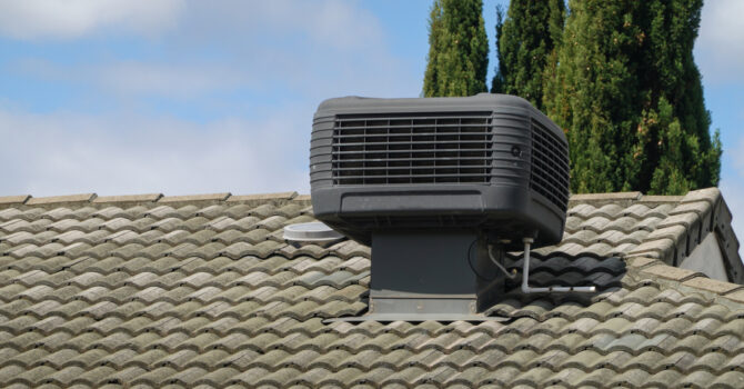 Evaporative cooling unit on roof of house