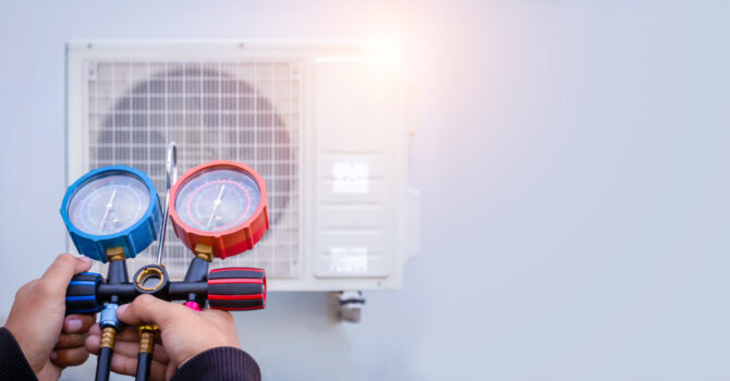 Air conditioner technician checks the operation of an outdoor AC unit