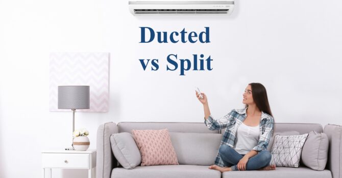 Young woman sitting on a couch operating a split system and the words "Ducted vs Split"
