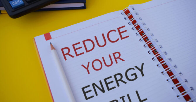 Reduce your energy bill text written in notebook